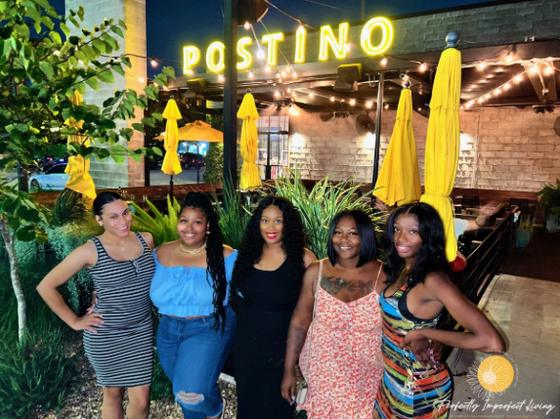 Members together outside Postino